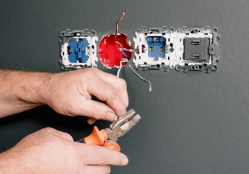 Electrician installing electrical plugs